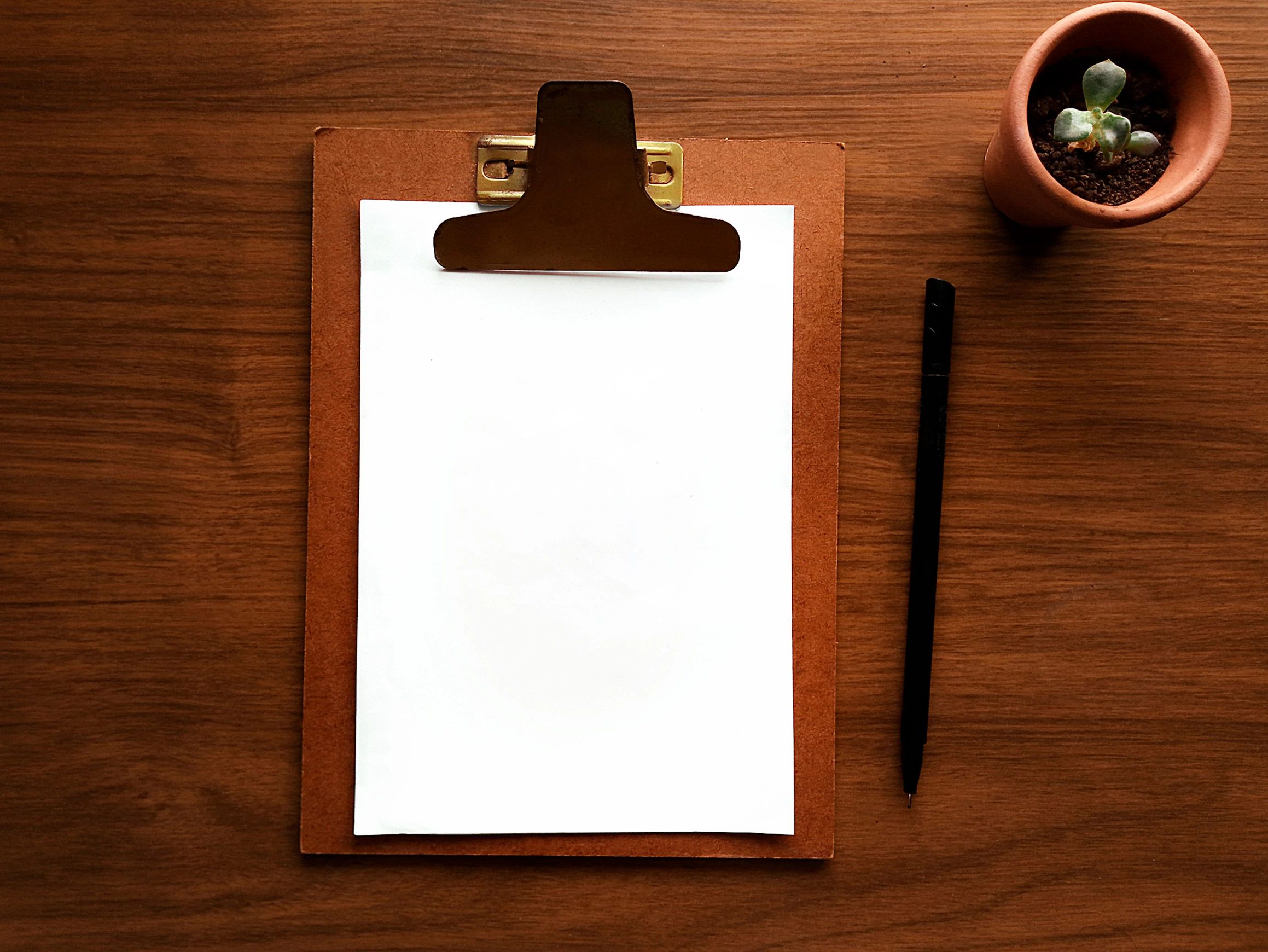 Clipboard and documents on a desk representing privacy and data handling