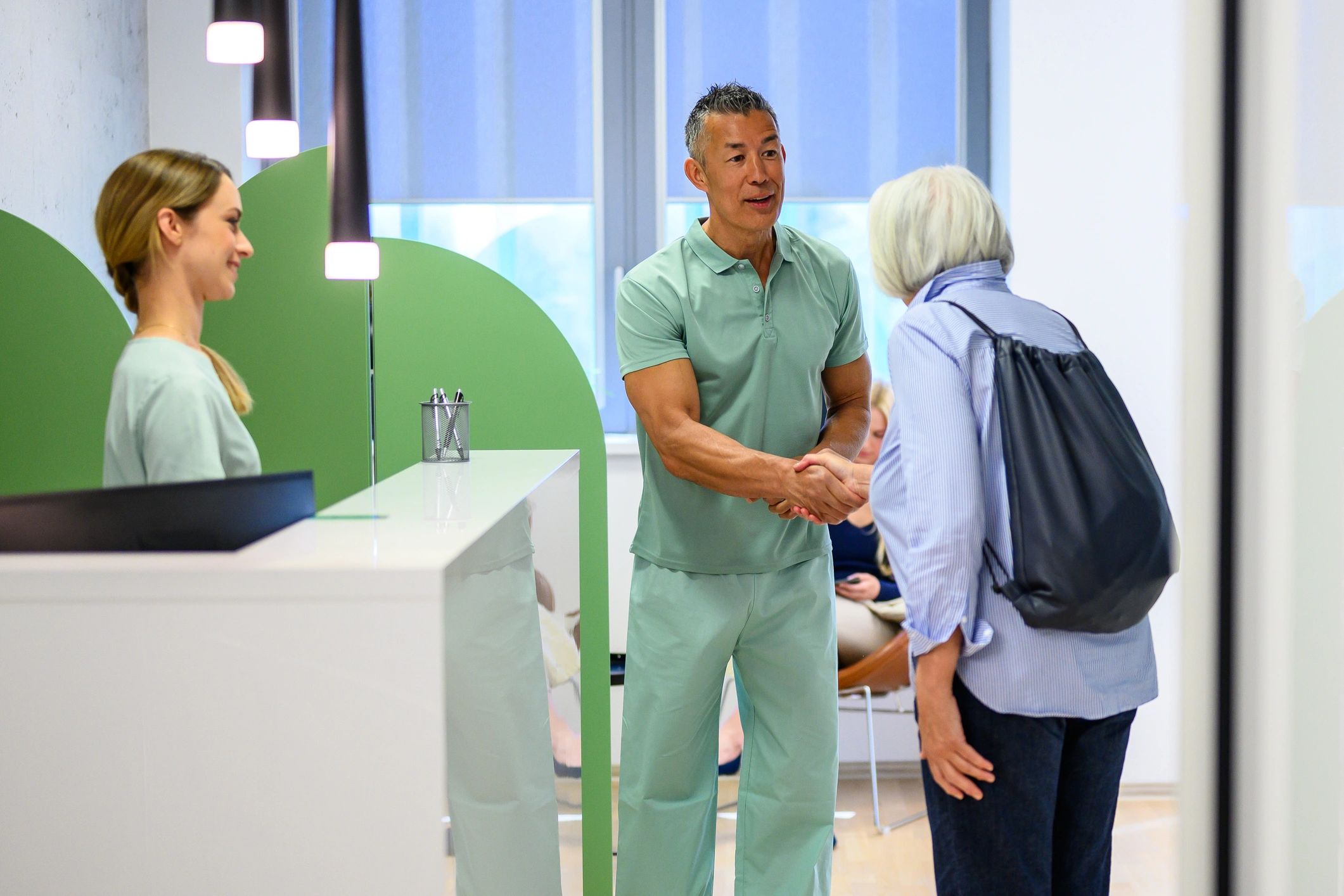 Healthcare professional greeting a patient in a modern clinic