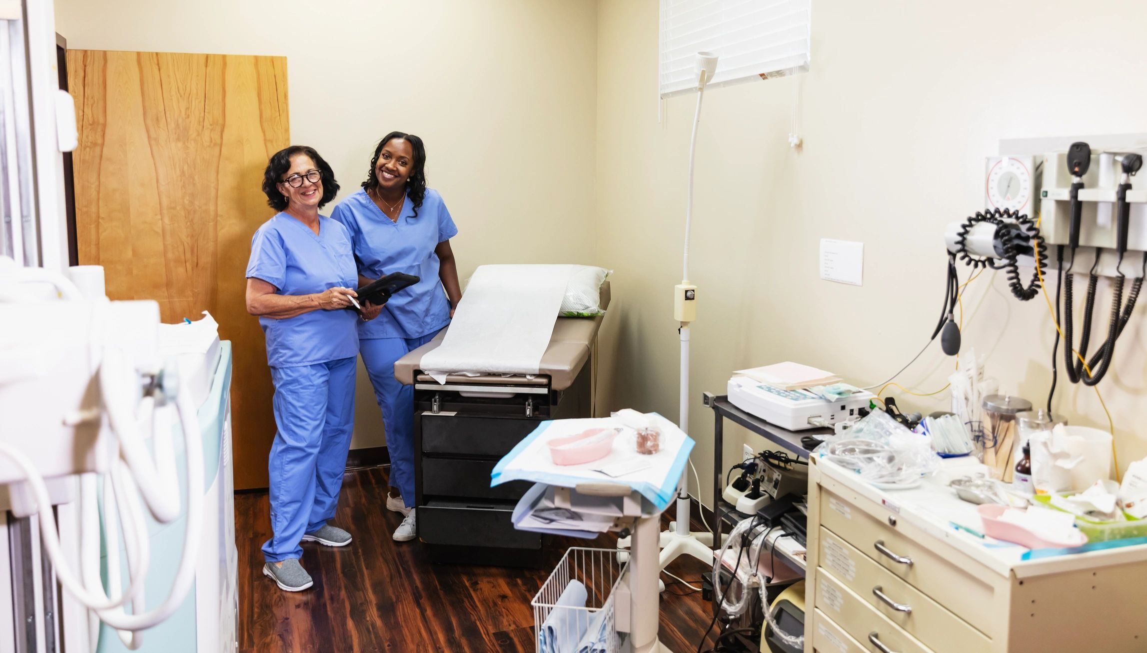 Healthcare professionals standing together in an examination room