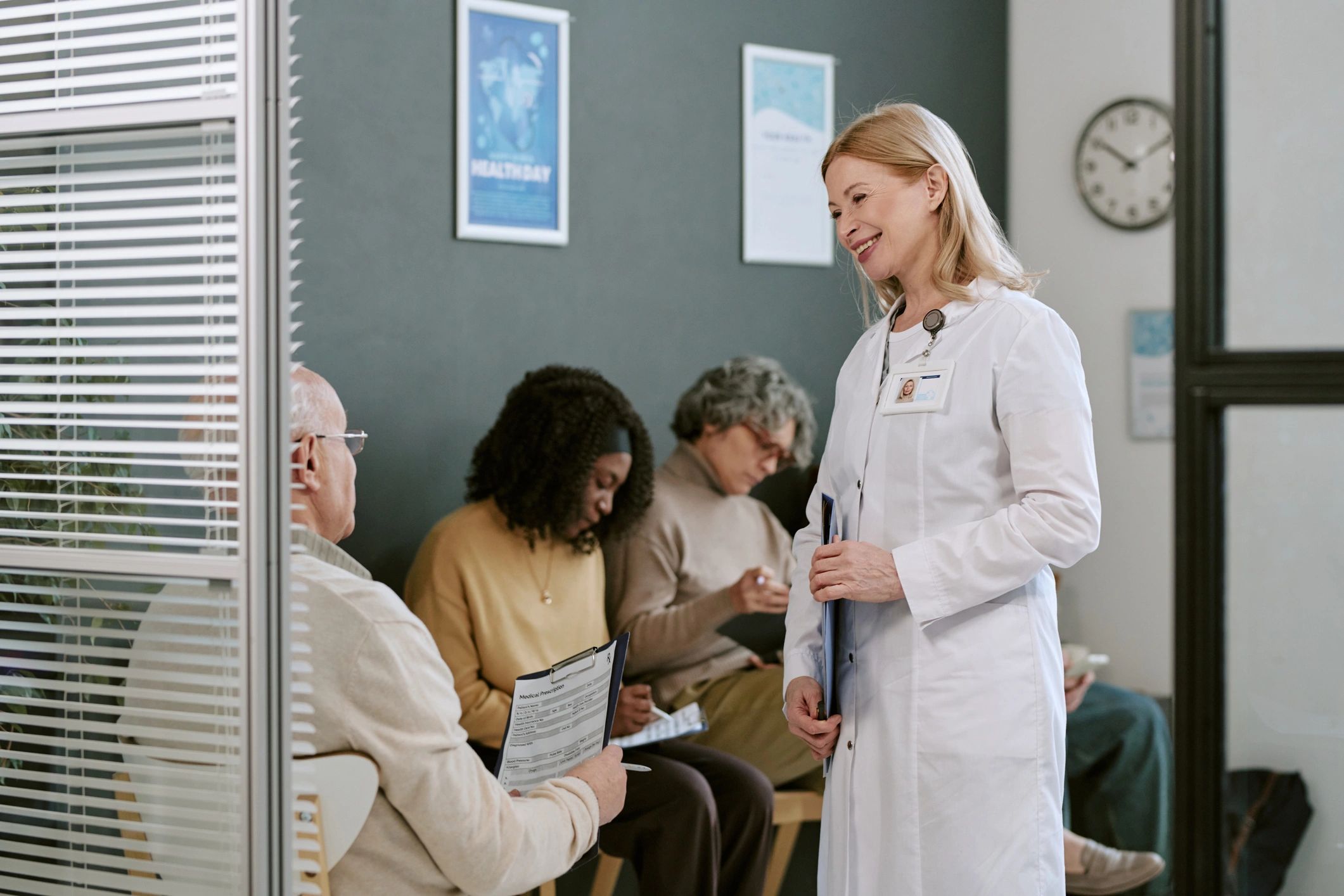 Doctor speaking with patients in a clinic waiting room