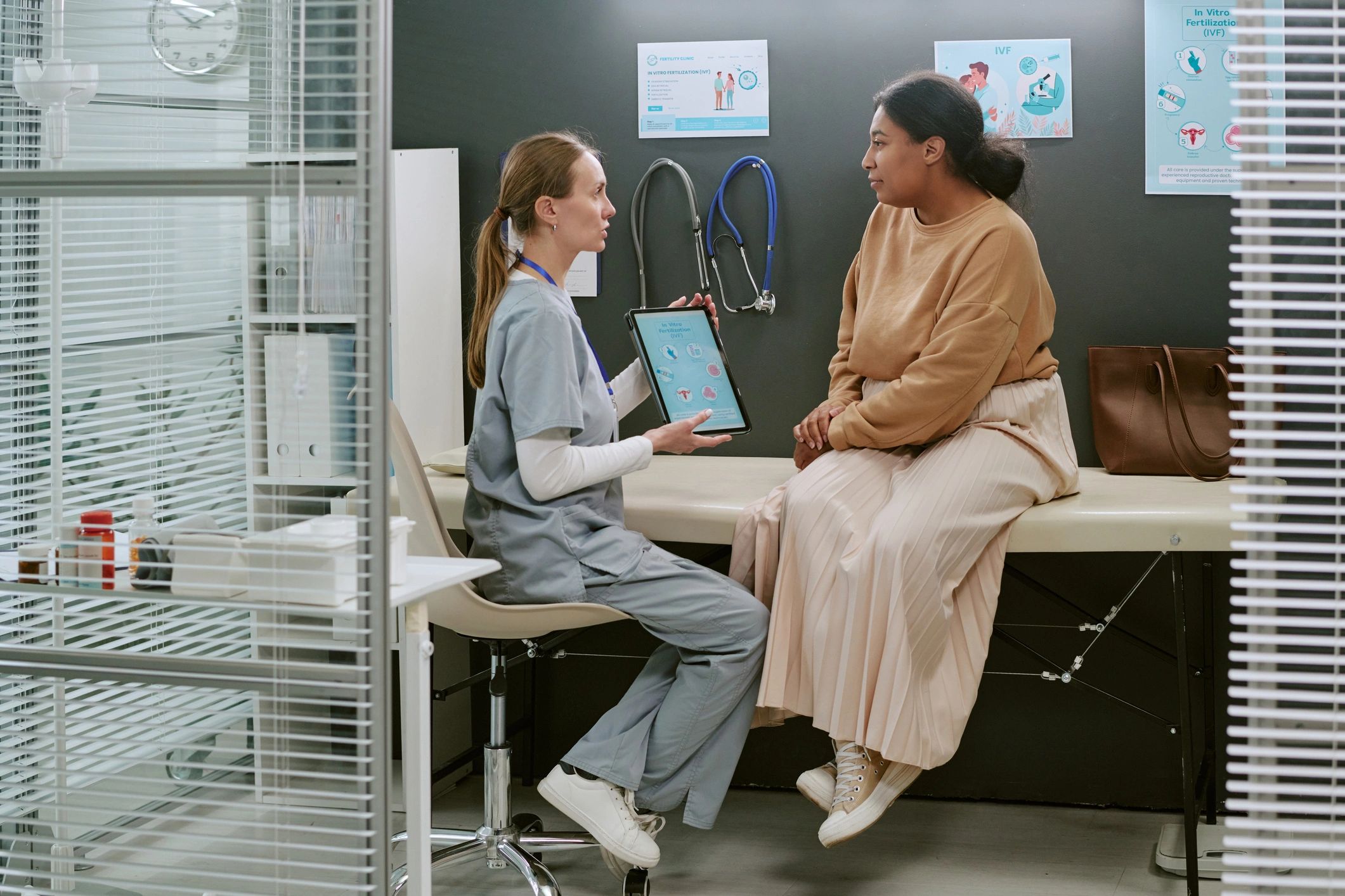 Doctor discussing information with a patient in a clinic consultation room